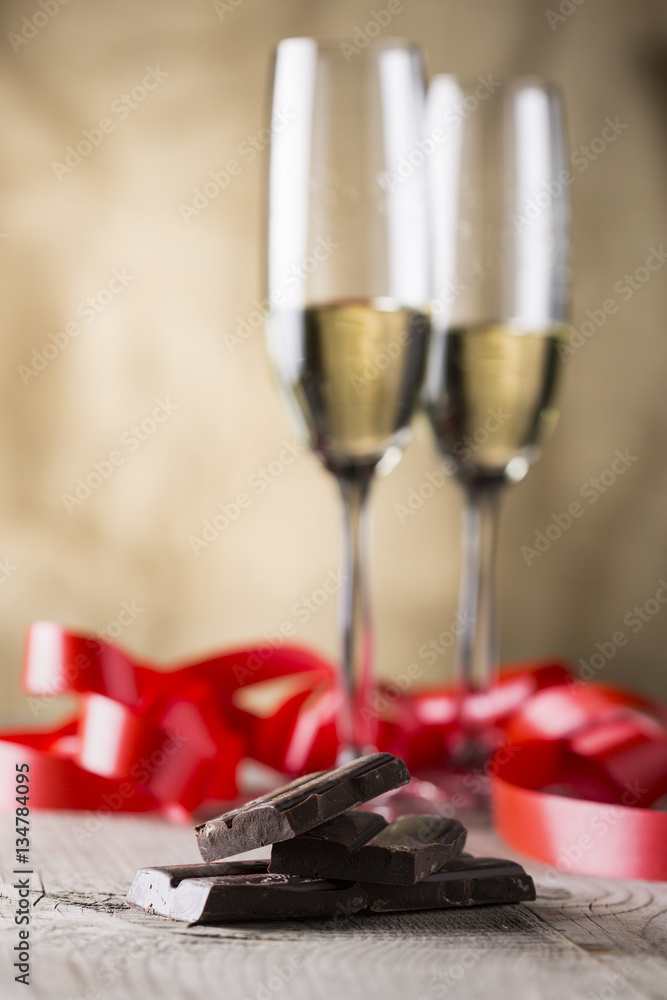 chocolate and two champagne glasses with red ribbon .valentines