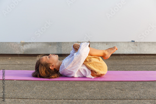 Baby doing yoga on the roof