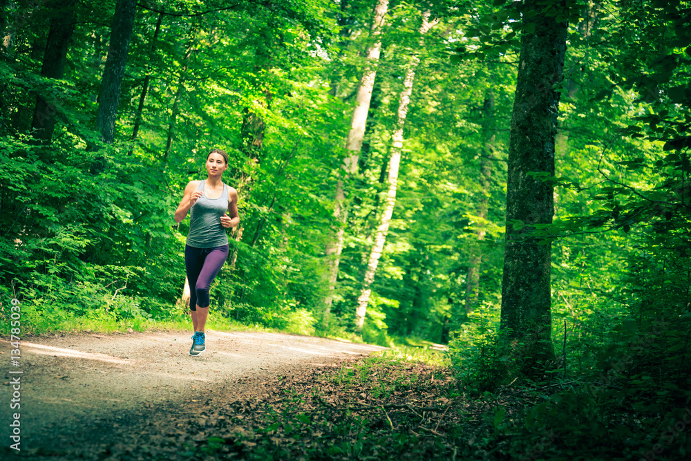 Young Woman Jogging In The Forest Young Woman Jogging In The Forest