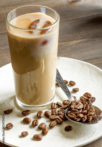 coffee with ice in glass on wooden background