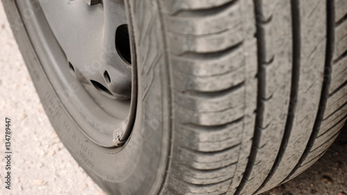 Close-up of car wheel parts - tire, rim. Vehicle components concept. Detailed shot.