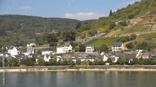 RHINE RIVER, GERMANY - SEP 14, 2016 - 	Pan past small German town with church on the 		 Rhine River, 	 Germany
 photo