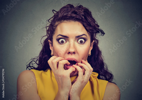 Scared shocked woman isolated on gray background