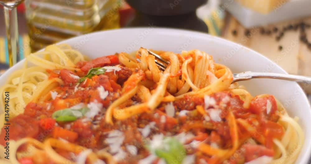 Dolly close up push in view of Italian pasta (spaghetti, linguini) with tomato sauce Dolly close up push in view of Italian pasta (spaghetti, linguini) with tomato sauce