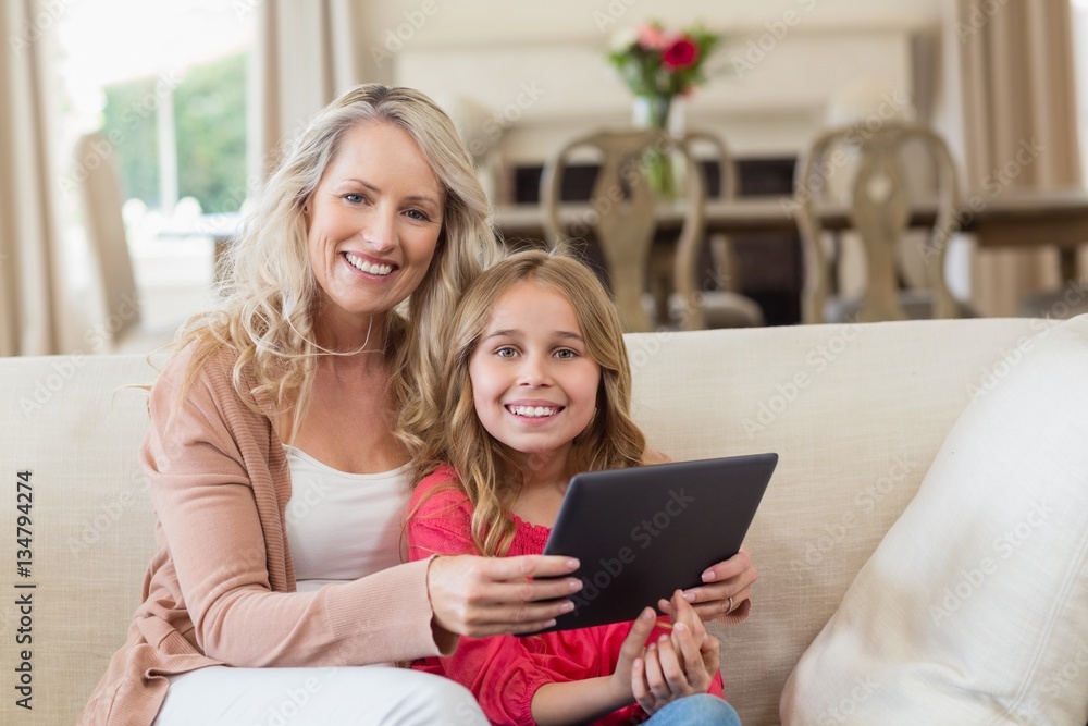 Mother and daughter using digital tablet at home Mother and daughter using digital tablet at home