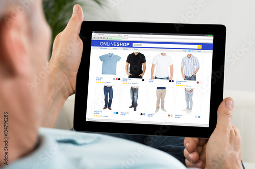 Close-up Of Person Shopping Online On Digital Tablet