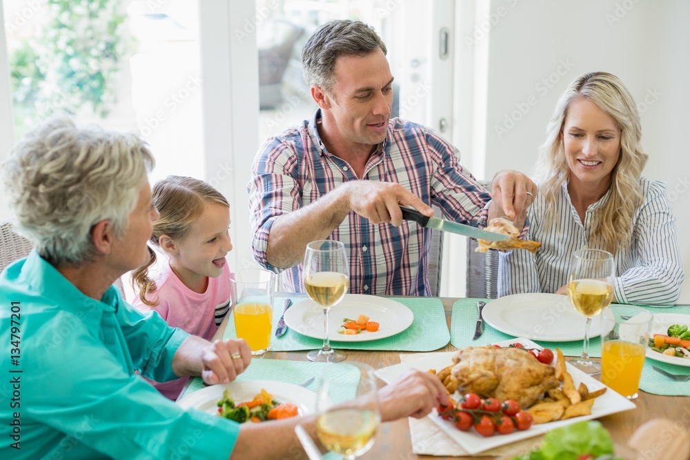 Multi- generation family having meal on dinning table Multi- generation family having meal on dinning table