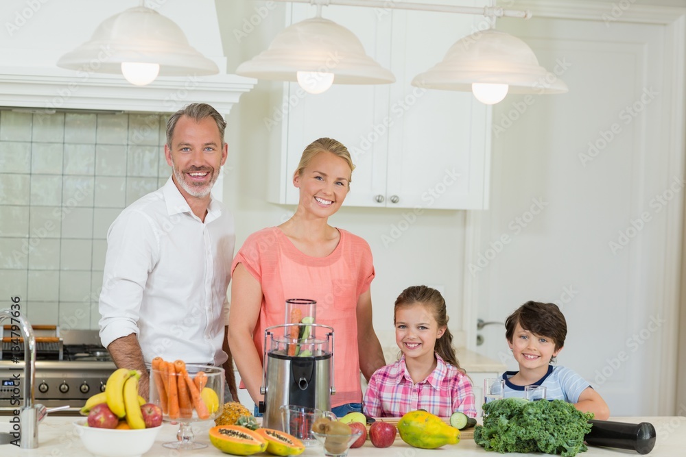 Portrait of parents and their two kids standing in kitchen Portrait of parents and their two kids standing in kitchen