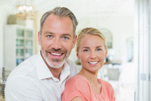 Couple embracing each other in kitchen