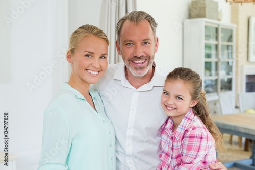 Portrait of parents with her daughter at home