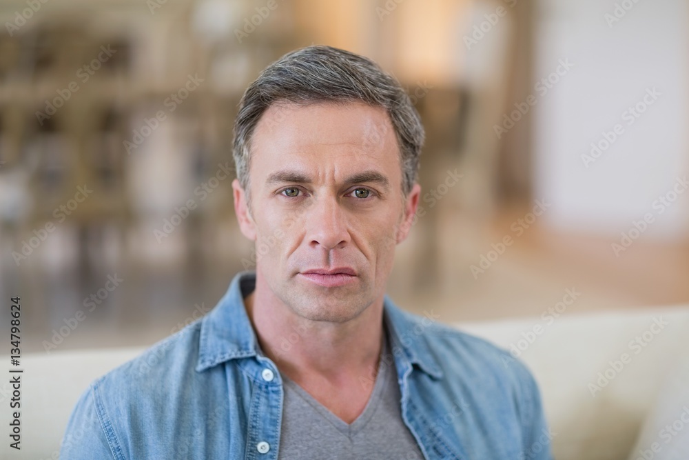 Portrait of man sitting in living room Portrait of man sitting in living room
