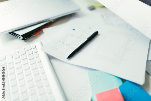 Designer desktop with sketches and computer