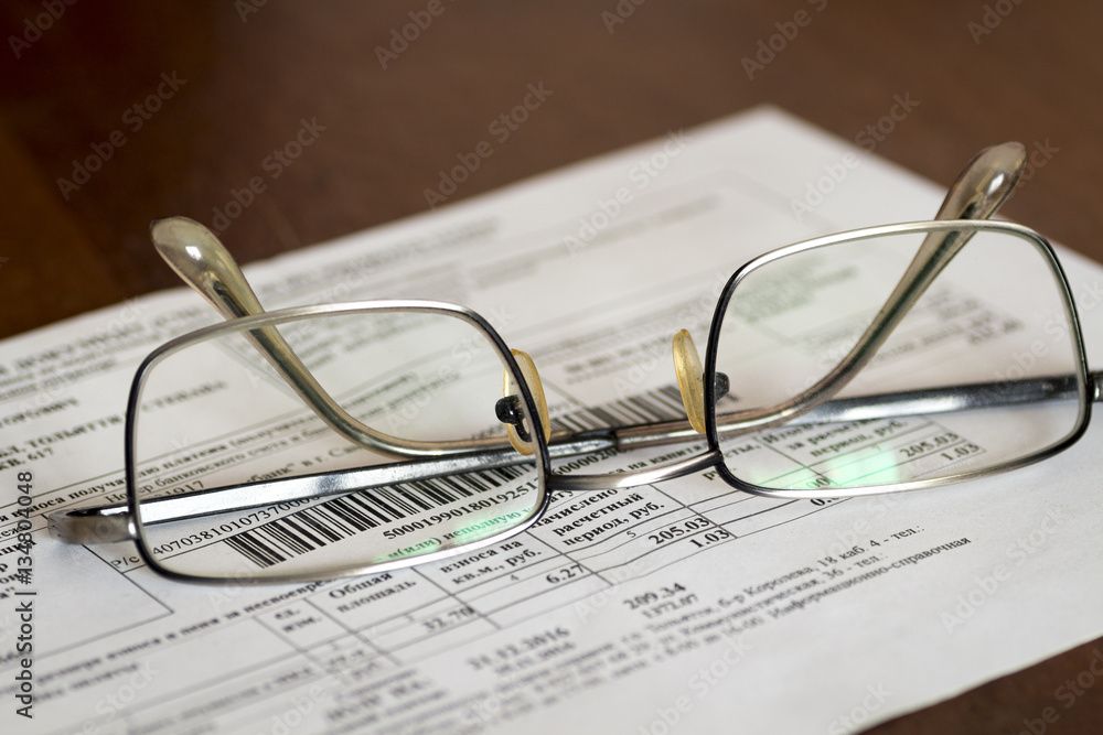 Glasses and receipt of payment on the table close-up. Glasses and receipt of payment on the table close-up.