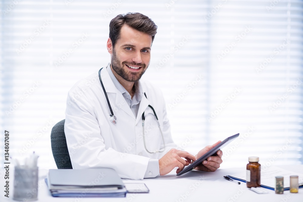 Portrait of male doctor using digital tablet Portrait of male doctor using digital tablet