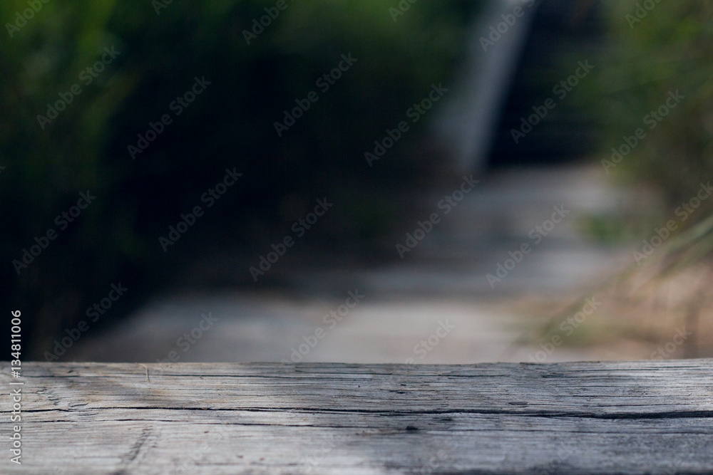 Old pine boards next to blurred green grass. Blurred background. Old pine boards next to blurred green grass. Blurred background.