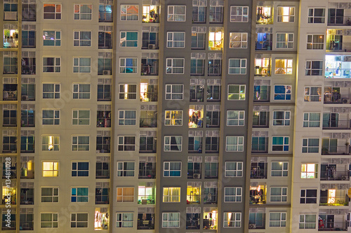 Apartment windows at night showing a vibrant community of condos © Travis