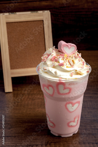 Obraz na płótnie Pink milk shake with heart shape marshmellows topping on wooden w salonie
