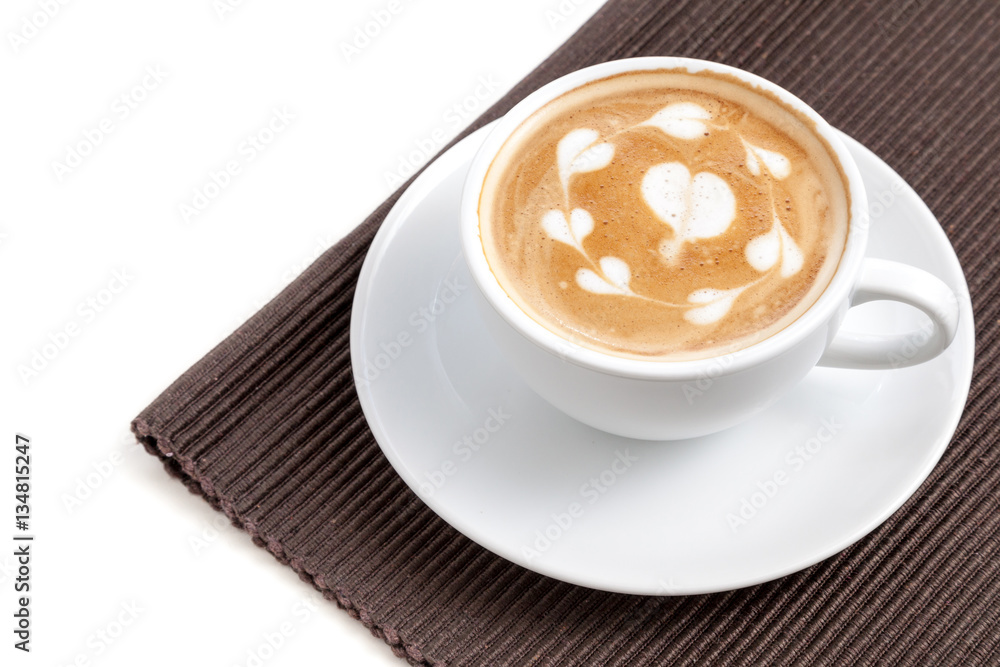 Coffee cup of latte art, many heart shapes on top, place on napk