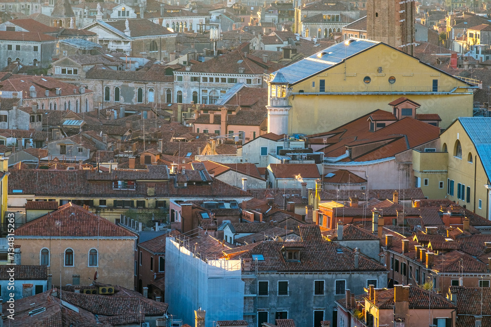 Aerial view of Venice, Italy, at sunset with rooftops of buildings and vintage colors in winter sunset.