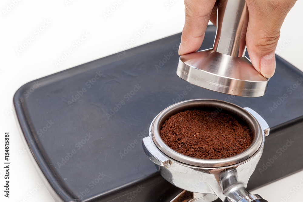 Barista is tamping coffee ground on the rubber, prepare to brew