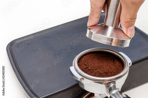 Obraz na płótnie Barista is tamping coffee ground on the rubber, prepare to brew w salonie