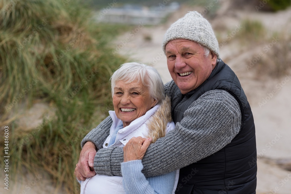 Fototapeta premium Happy senior couple standing together on the beach
