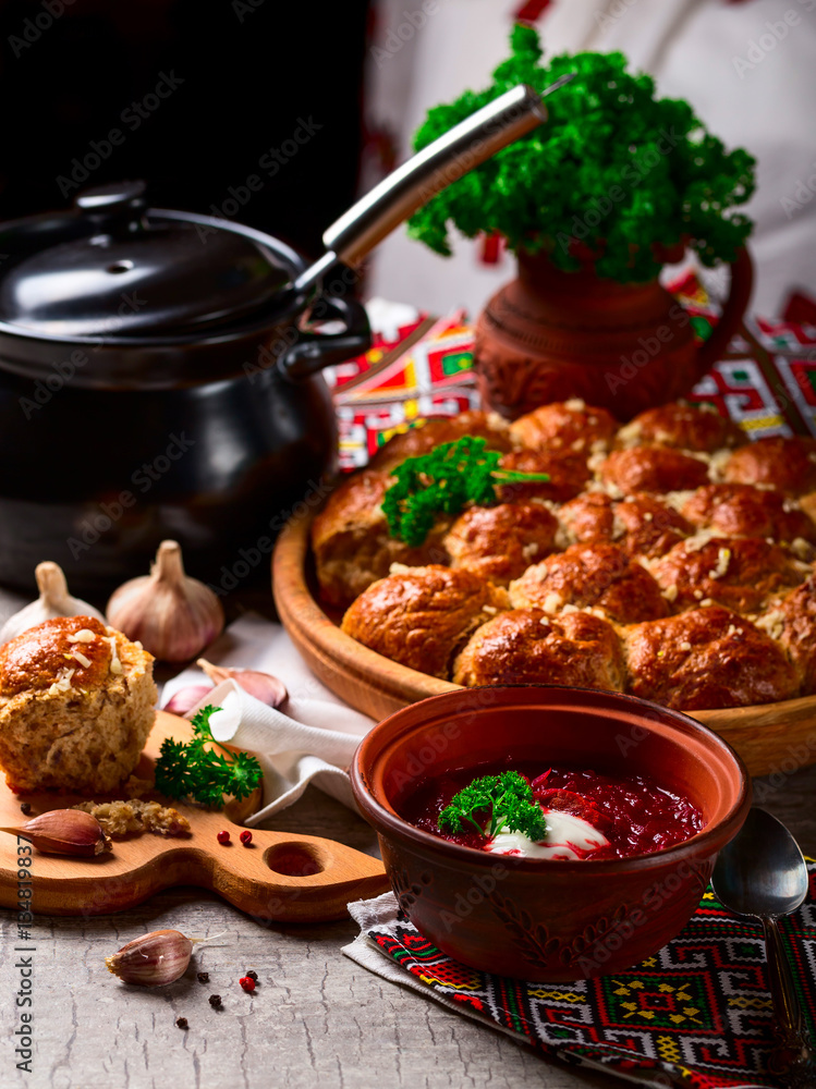 Ukrainian borsch and dumplings with garlic on the table Ukrainian borsch and dumplings with garlic on the table