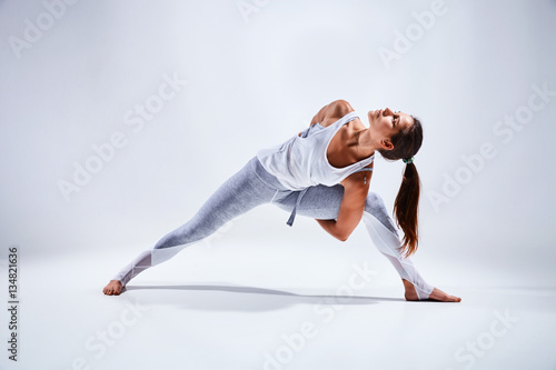 Woman doing yoga isolated on white background