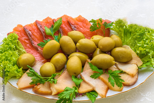 Smoked salmon and fish with olives appetizer. Russian cuisine