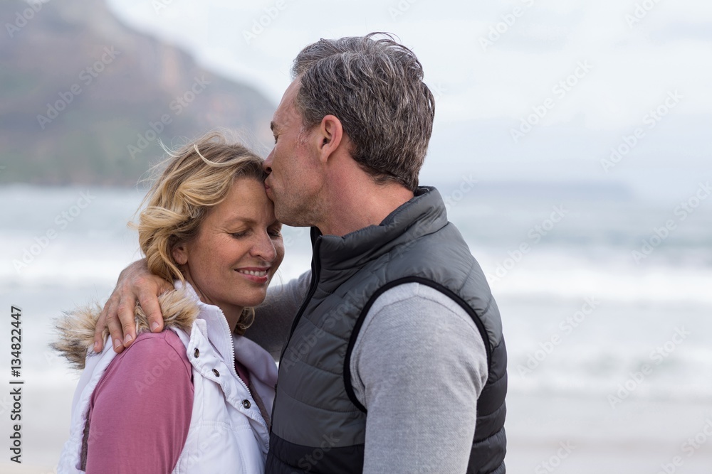 Mature man kissing woman on forehead Mature man kissing woman on forehead