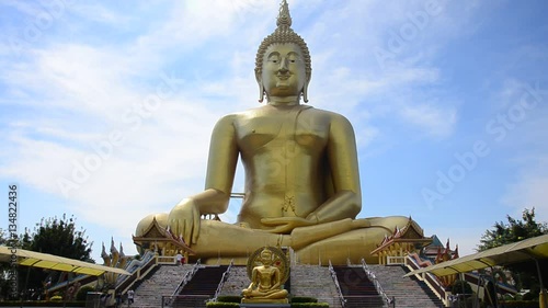 Asian thai worker people and foreigner travelers visit and pray respect with golden big buddha statue at Wat Muang temple on January 25, 2017 in Ang Thong, Thailand photo