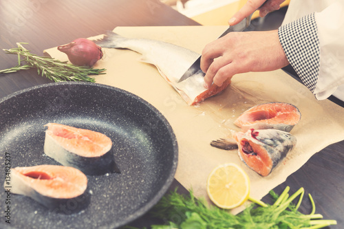 Photography seafood - chef slicing salmon fish for preparing