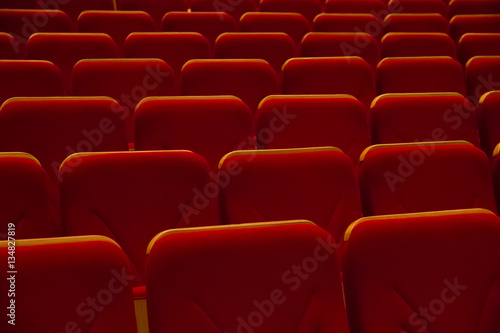 Rows of red chairs in movie theater