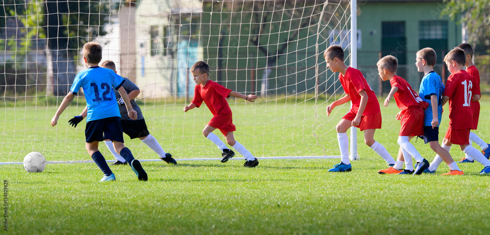 Obraz premium Boys kicking ball