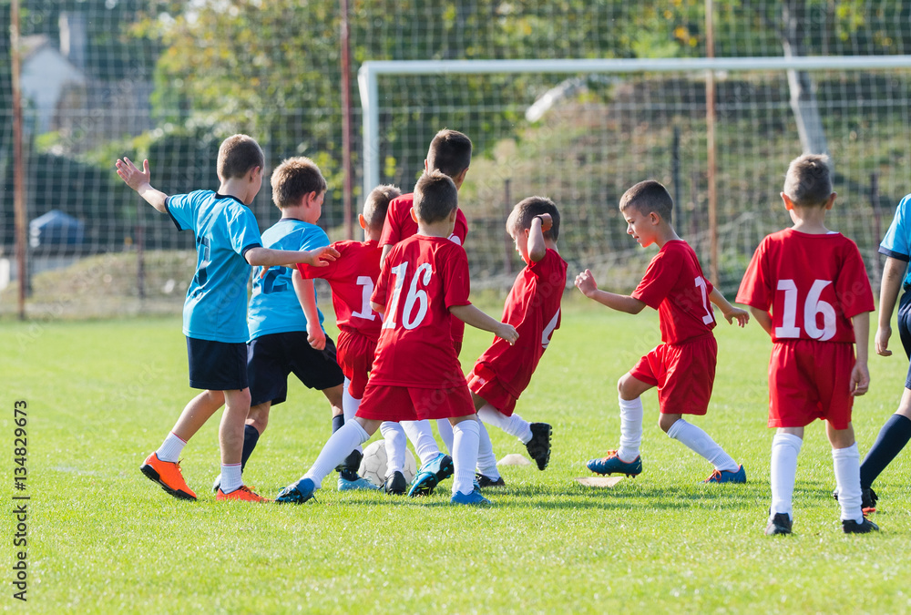 Obraz premium Boys kicking ball