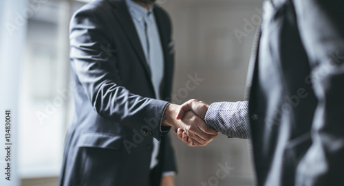 Two cropped businessmen handshaking. photo