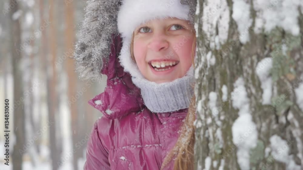 Happy child playing with snow in winter forest.
Happy child playing with snow in winter forest.
