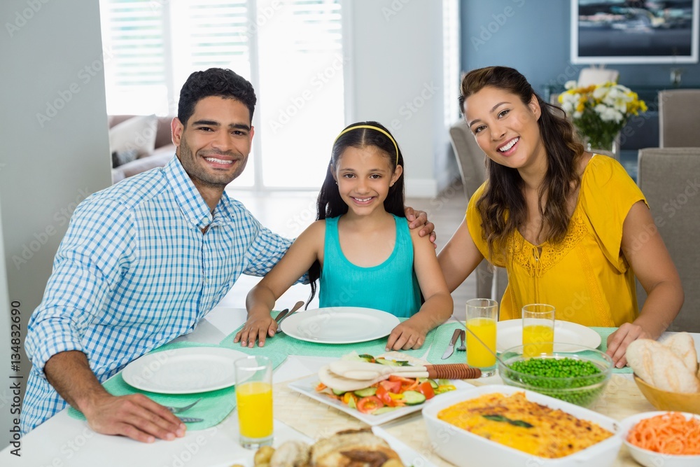 Daughter and parents having meal on table at home Daughter and parents having meal on table at home