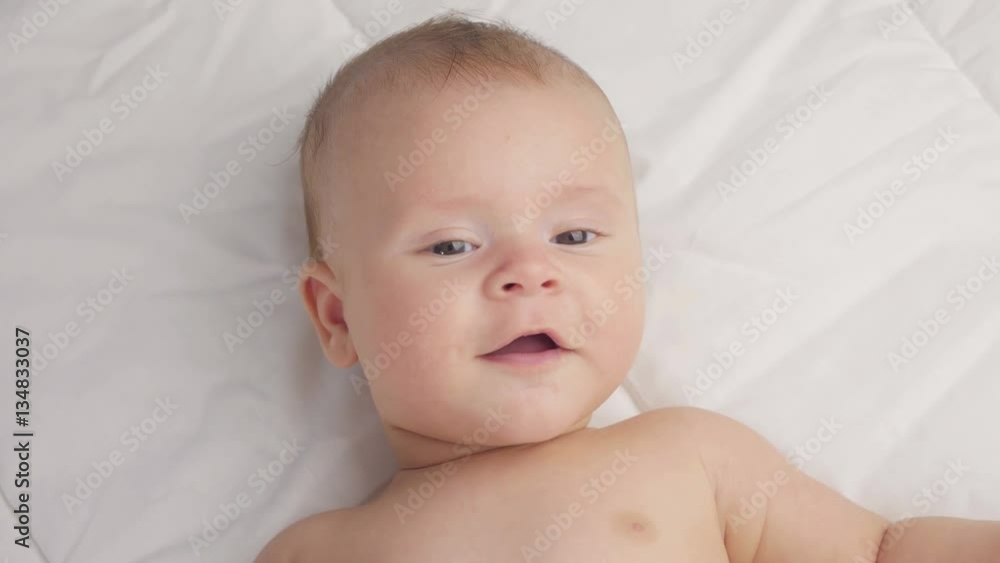 Cute 4-month-old baby in blanket. Close up. Cute 4-month-old baby in blanket. Close up.