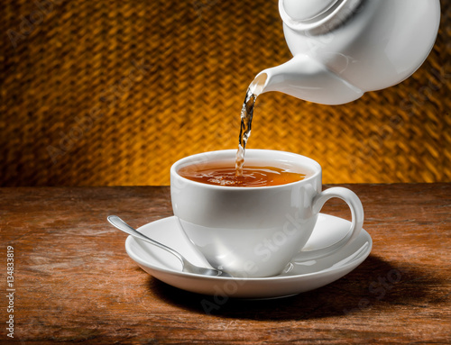 Tea being poured into tea cup