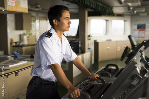 Young Chinese Navigator Navigating his Ship