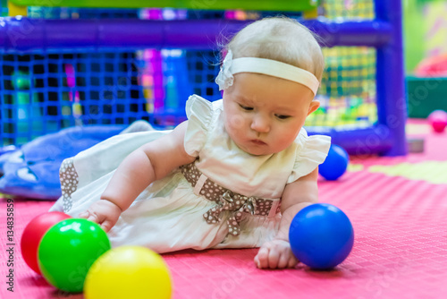 one of the babies playing in the nursery