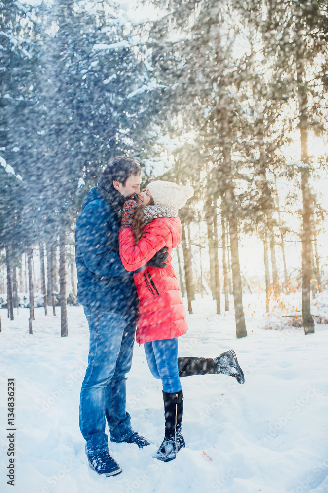 woman and man having fun in winter forest