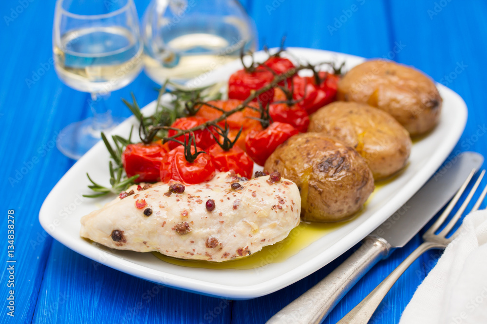 chicken with potato and tomato on dish chicken with potato and tomato on dish
