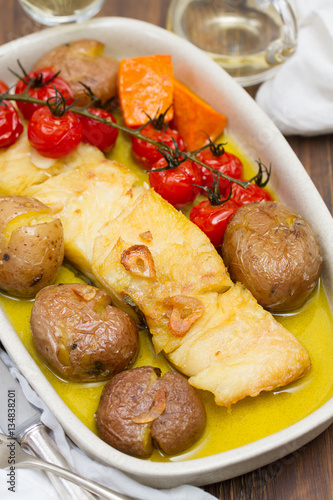 cod fish with potato and tomato cherry on dish