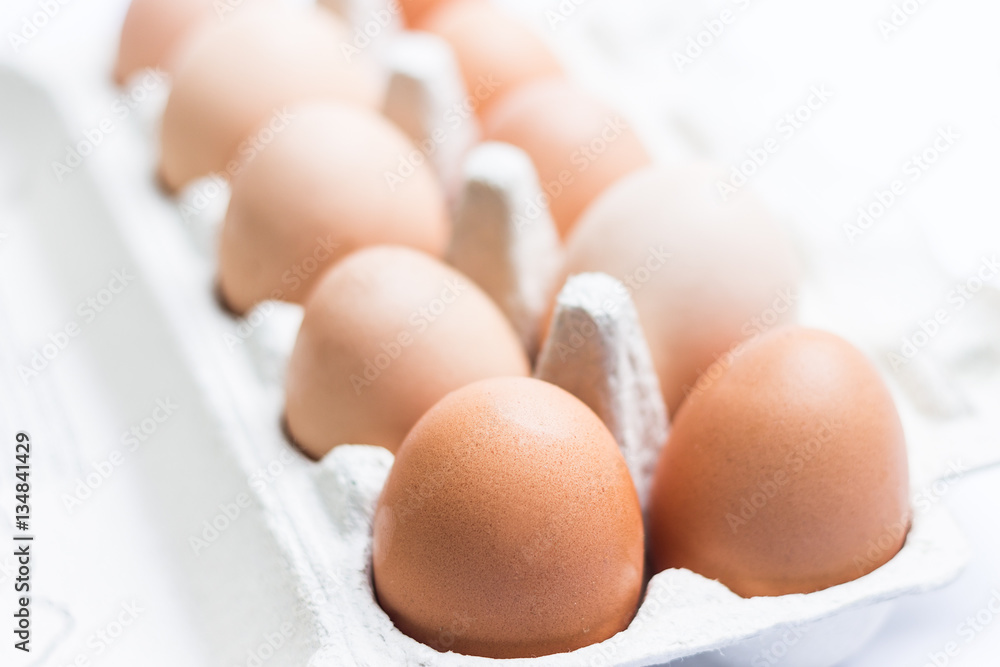 Eggs Inside Paper Box on Light Background Eggs Inside Paper Box on Light Background