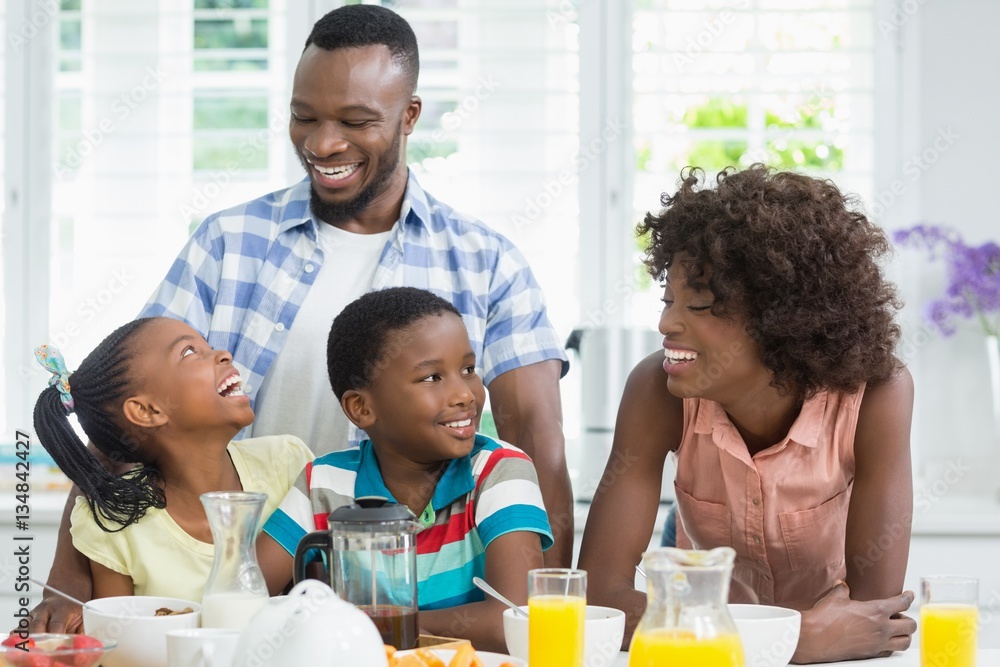 Kids and parents having breakfast on table at home Kids and parents having breakfast on table at home