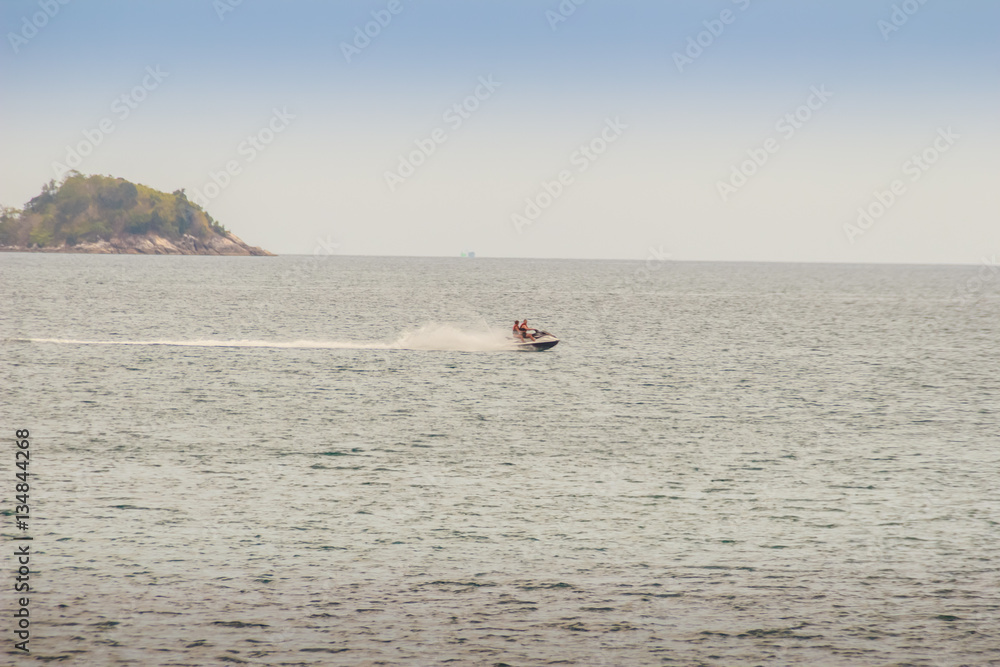 Naklejka premium Tourist enjoy jet ski riding around the Beautiful seascape view of Kalim beach, the small beach of Kalim fishermen village, Kalim Beach is nearby Patong beach.