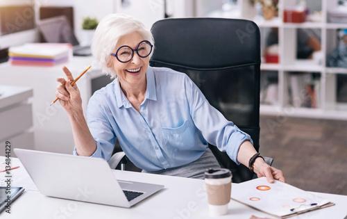 Photography Laughing aged woman enjoying her job