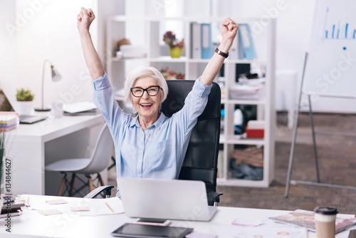 Konstfotografi Amused aged businesswoman expressing joy in the office